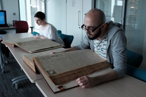 Volunteers reading First World War era newspapers at Newcastle City Library 