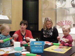 Modelling with playdough, amongst the ceramic display.